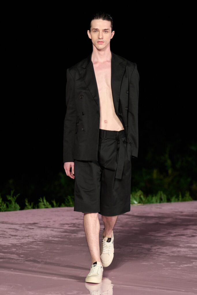 A relaxed black cotton jacket with shorts, featuring a collared design and buttoned details.