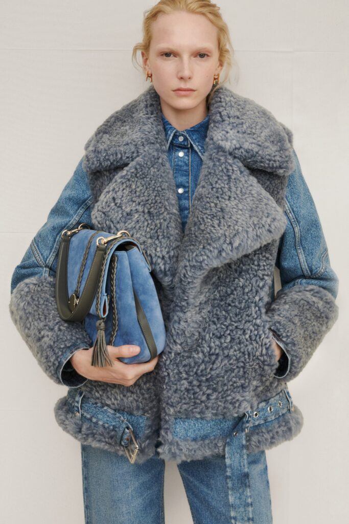 A relaxed blue denim jacket with fur detailing and matching pants.