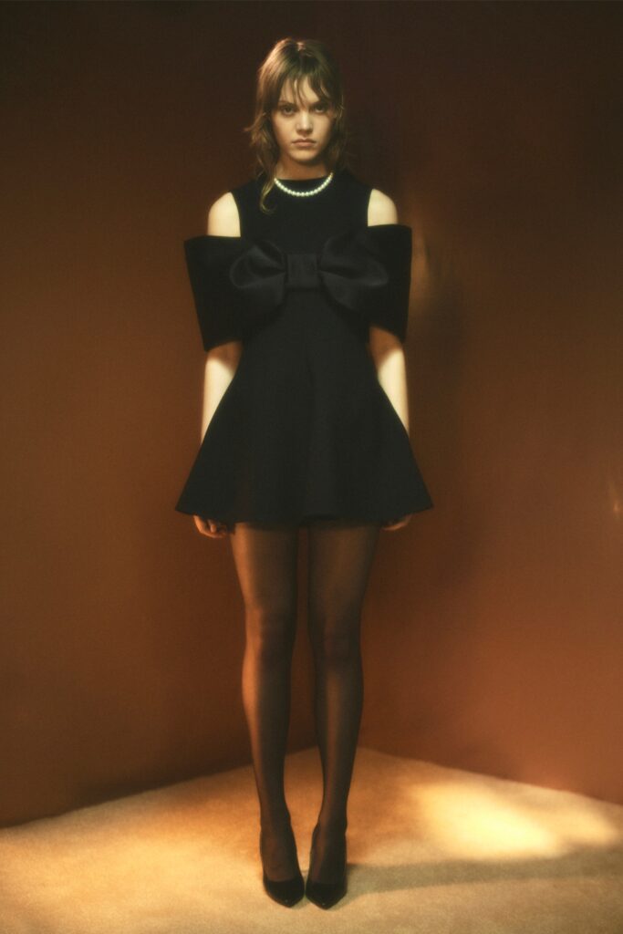 A fitted black dress with a sleeveless design and flared silhouette.