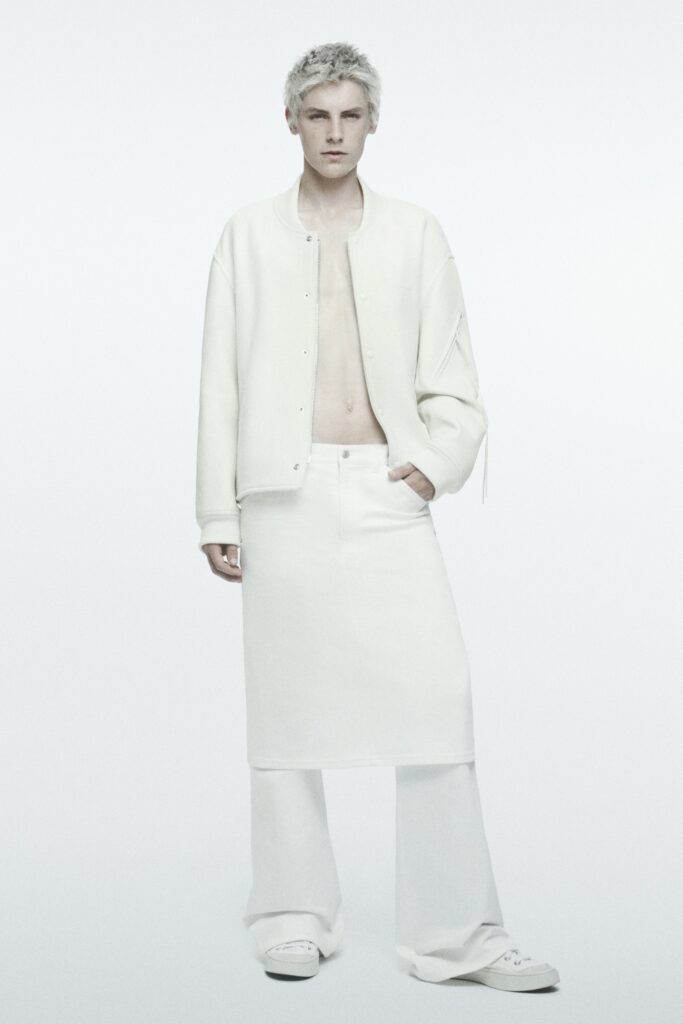 A relaxed white jacket with long sleeves and an asymmetric skirt for a modern look.
