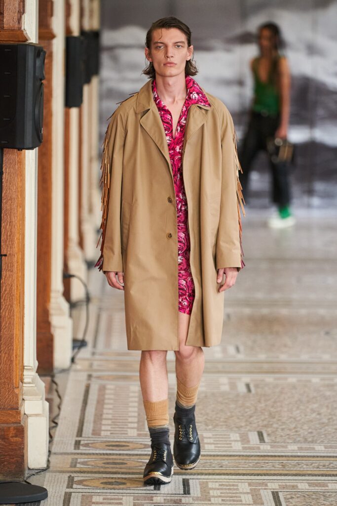 beige coat with fringed details and pink floral dress