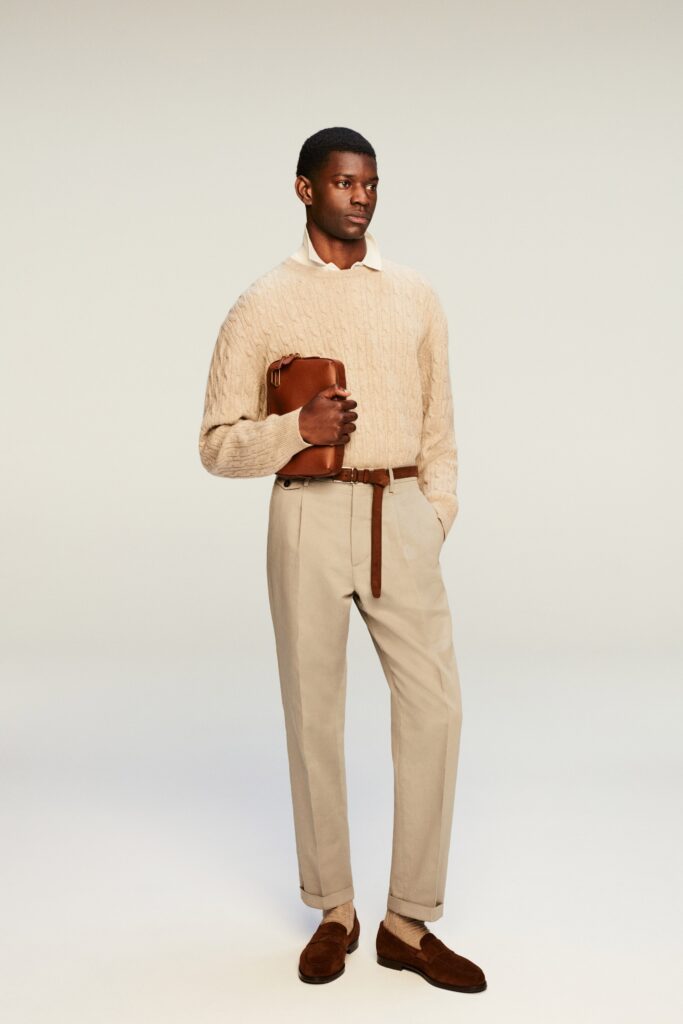 A relaxed beige cotton long-sleeve sweater paired with cream pants, featuring a textured design.