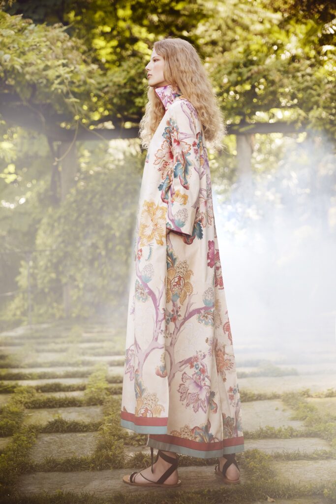 A relaxed beige silk dress with long sleeves and a floral design.