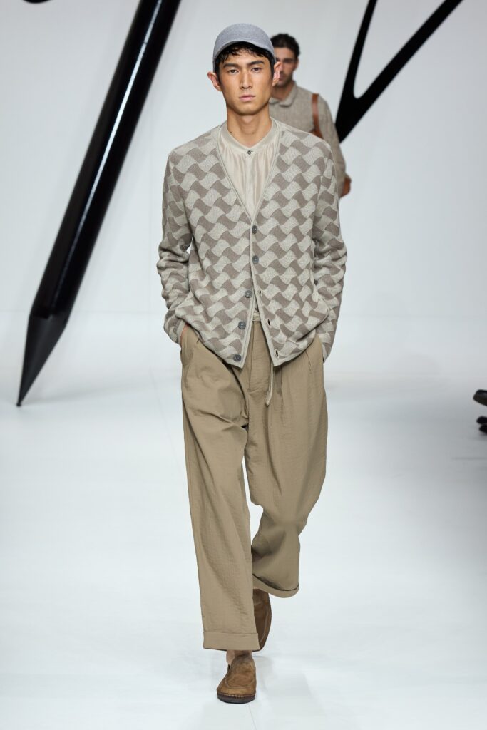 A relaxed beige printed cardigan paired with loose-fitting pants for a casual look.