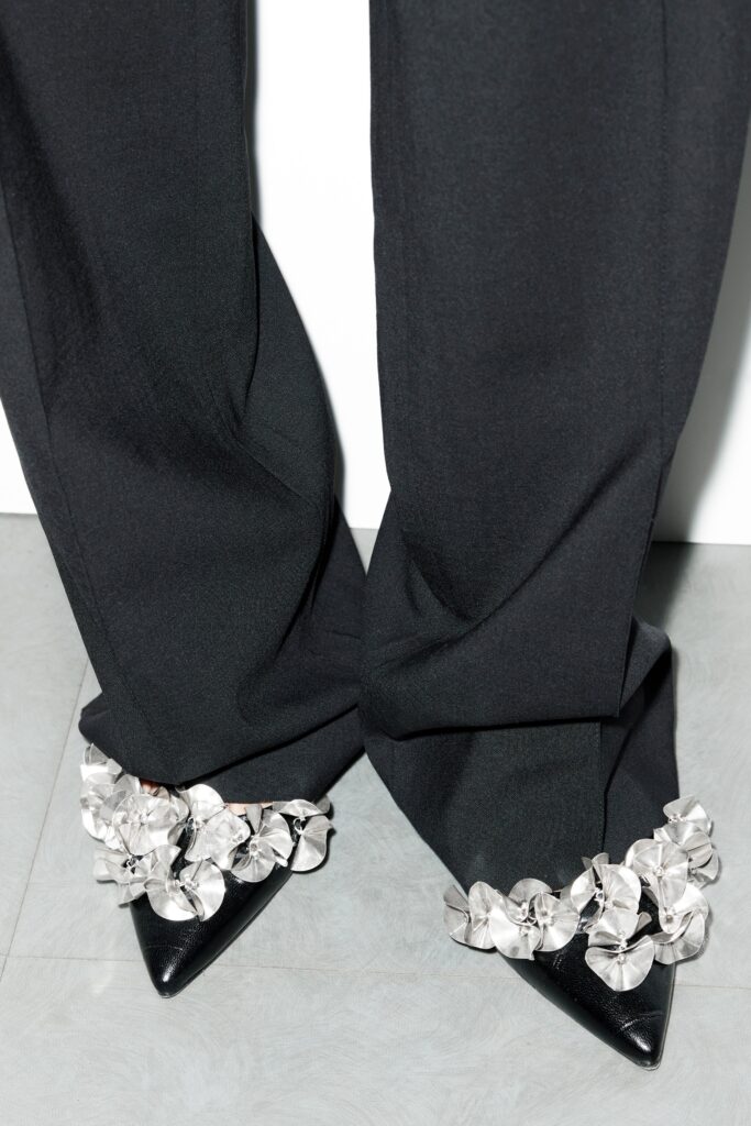 A pair of relaxed black pants with pleated details, perfect for a stylish look.