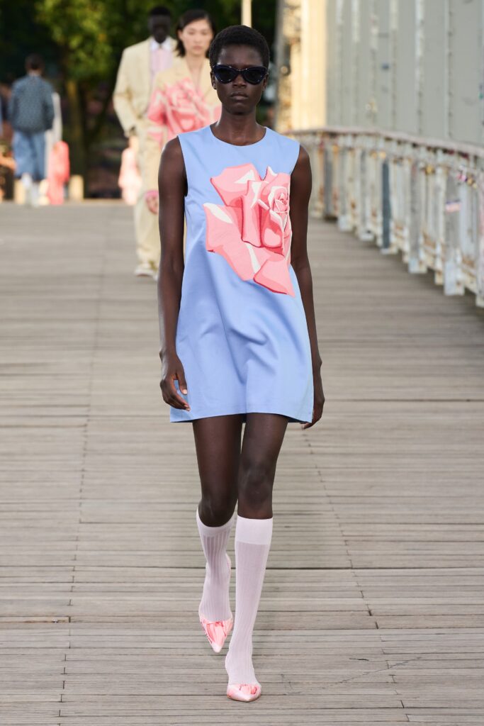 A relaxed blue cotton sleeveless dress featuring a floral design in pink.