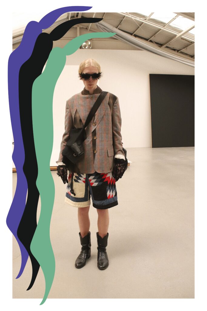 An oversized gray blazer paired with multicolor patterned shorts for a unique runway look.