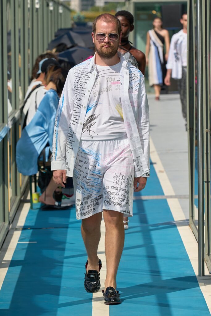A relaxed white shirt with multicolor prints paired with matching printed shorts.