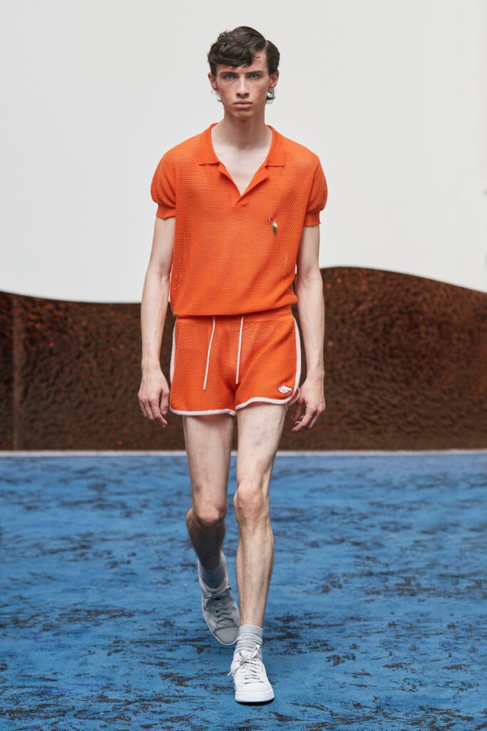 A fitted orange cotton shirt with short sleeves and matching shorts, featuring a striped design.