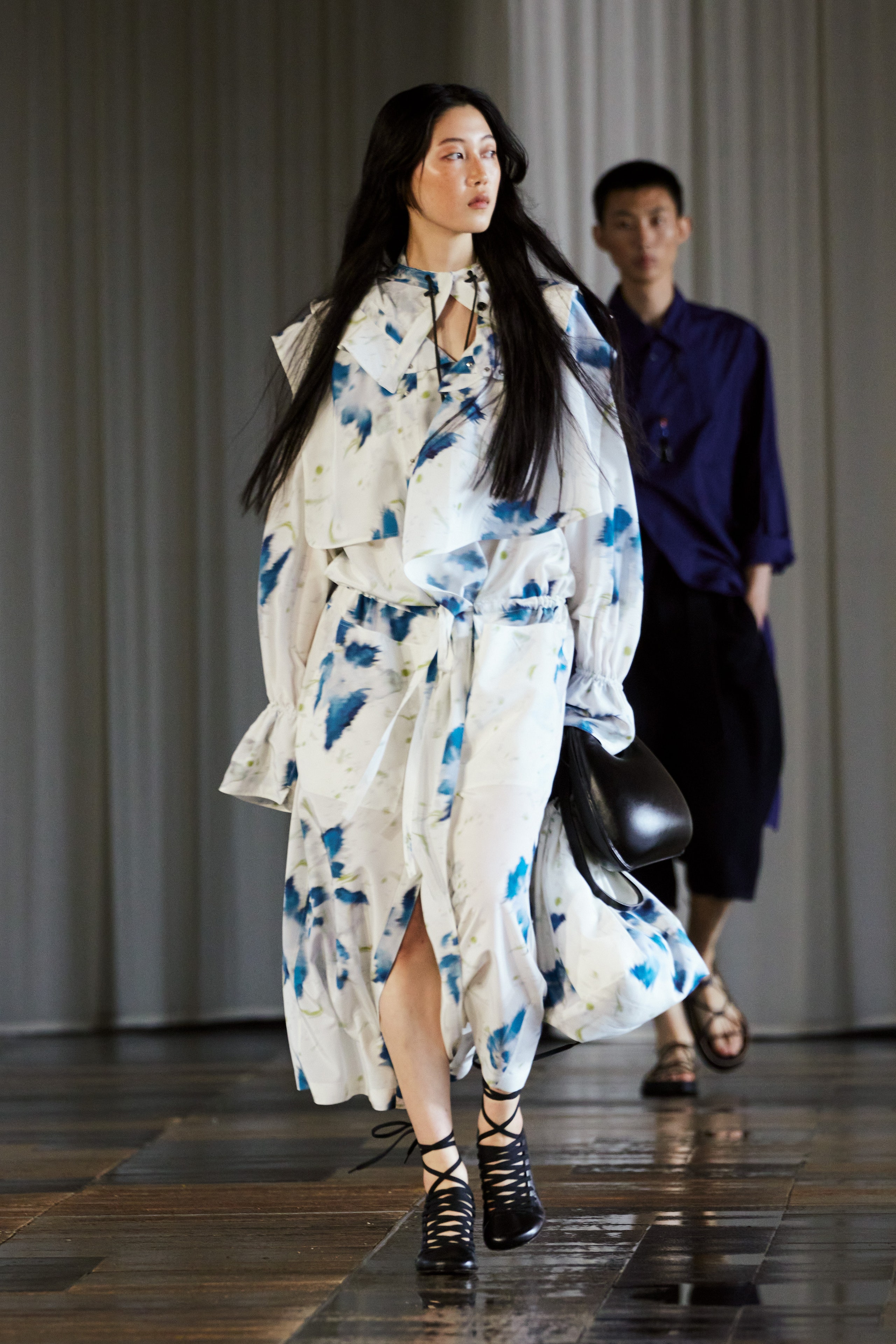 A relaxed white and blue printed dress with long sleeves and a V-neckline.