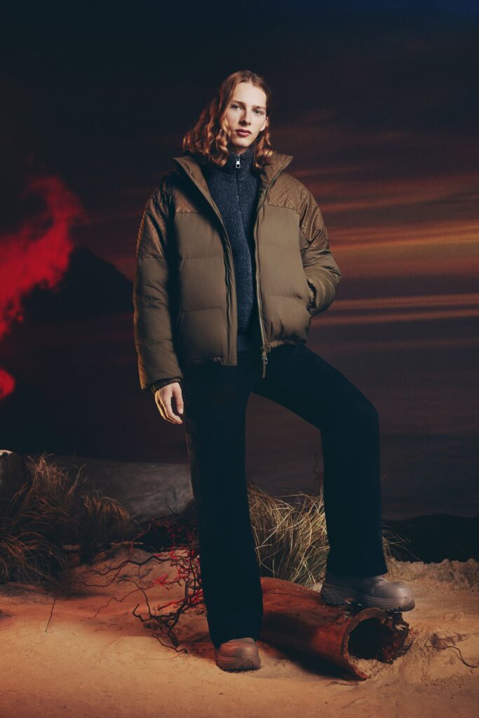 A relaxed green jacket paired with black straight-leg pants, featuring a collared design.