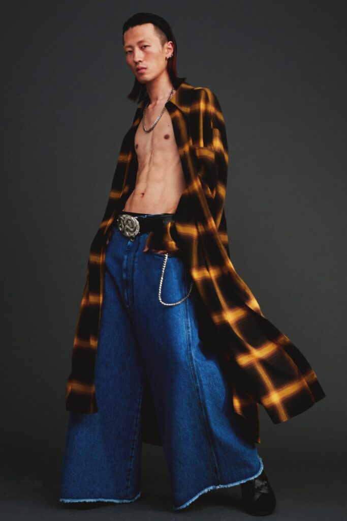A relaxed fit checked shirt with long sleeves paired with wide-leg denim pants.