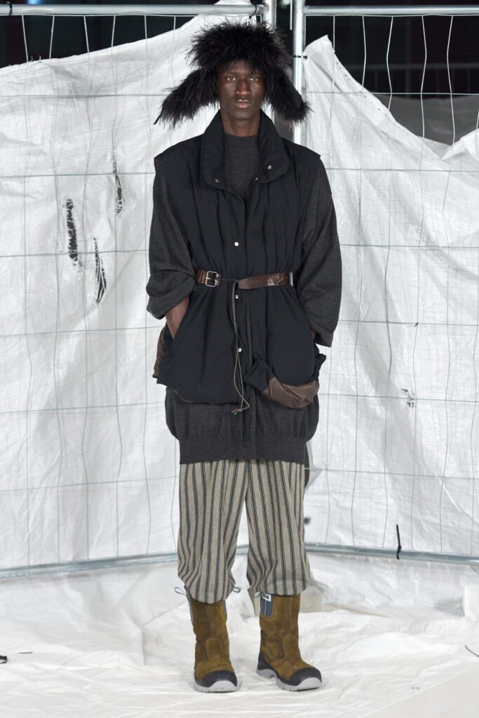 black vest gray top striped pants