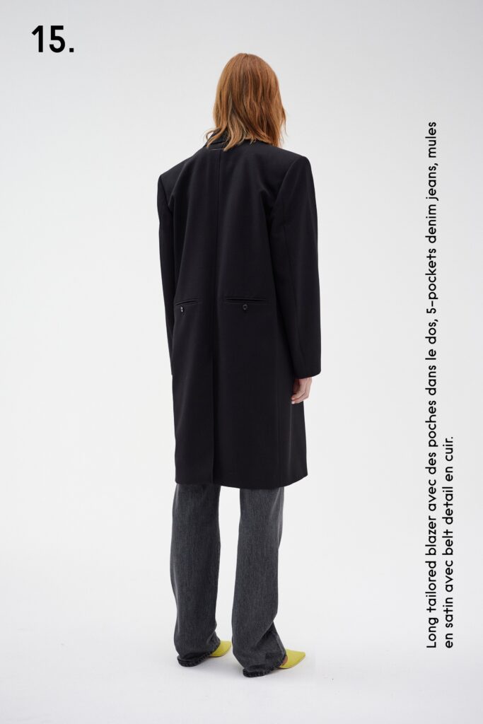 A relaxed black coat paired with gray straight-leg pants for a modern look.