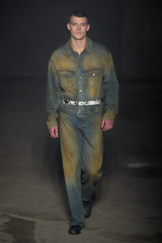 A relaxed fit blue denim jacket with long sleeves and straight-leg pants, featuring a buttoned design.
