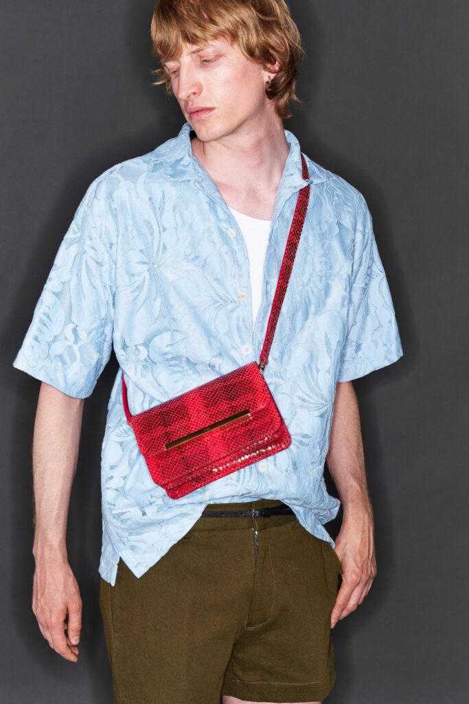 A relaxed blue printed short-sleeve shirt paired with green shorts for a casual look.