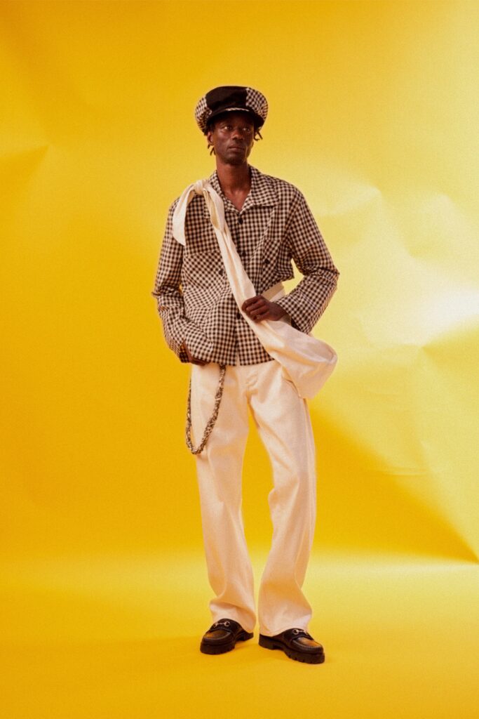 A relaxed fit long-sleeve checked shirt paired with white relaxed pants.