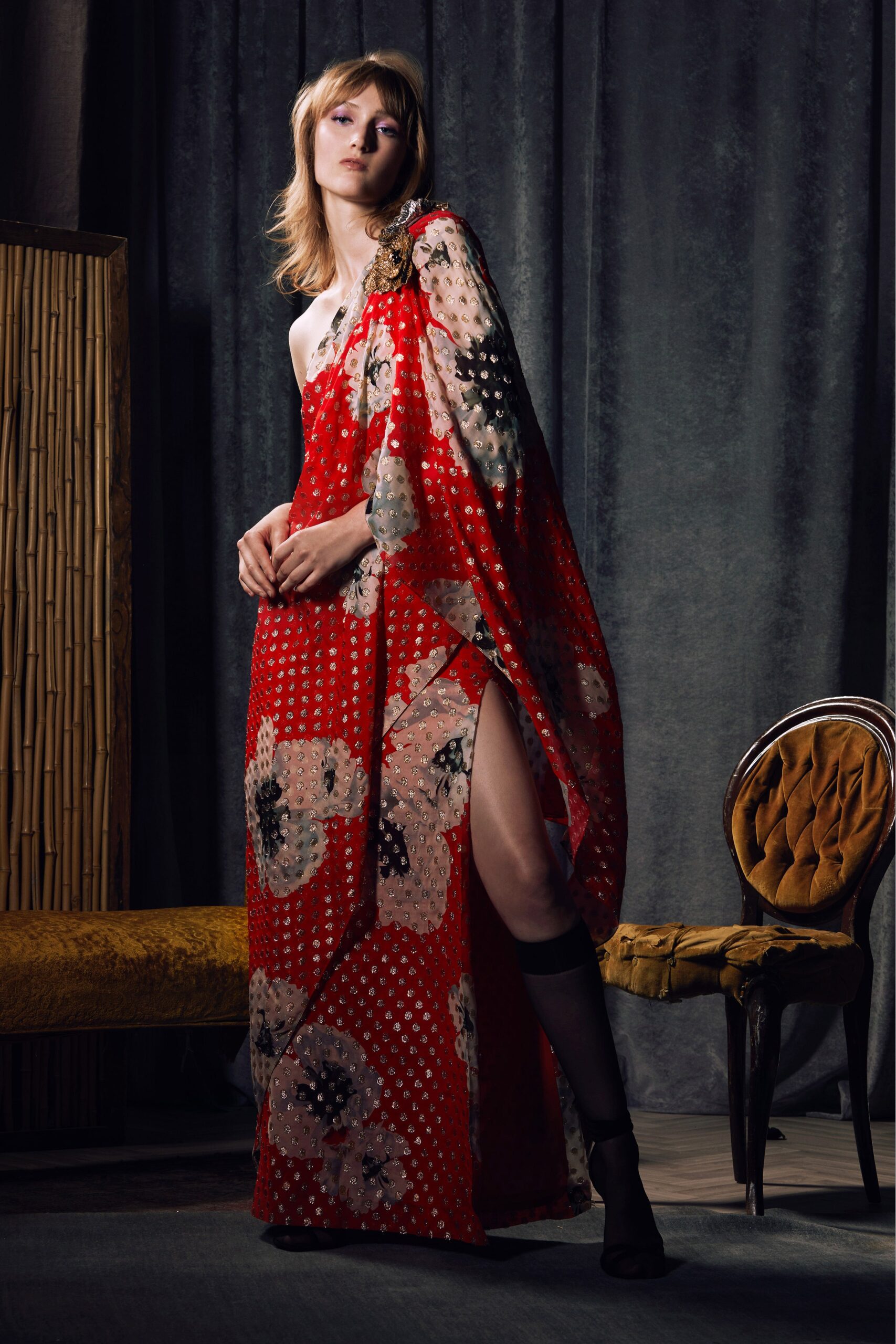 A relaxed red floral sleeveless dress with a high neckline and flared silhouette.