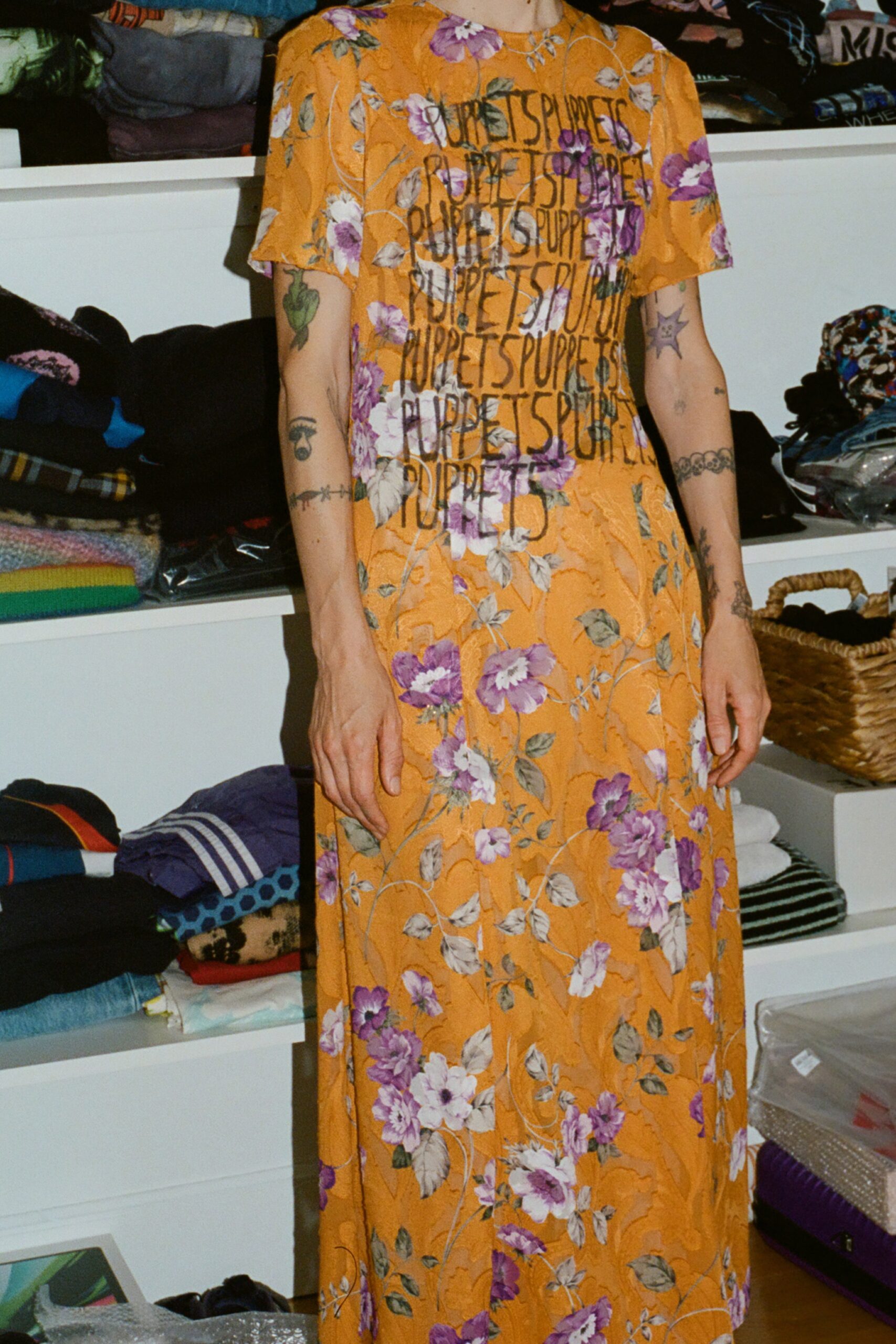 A relaxed orange floral dress with short sleeves and a high neckline.