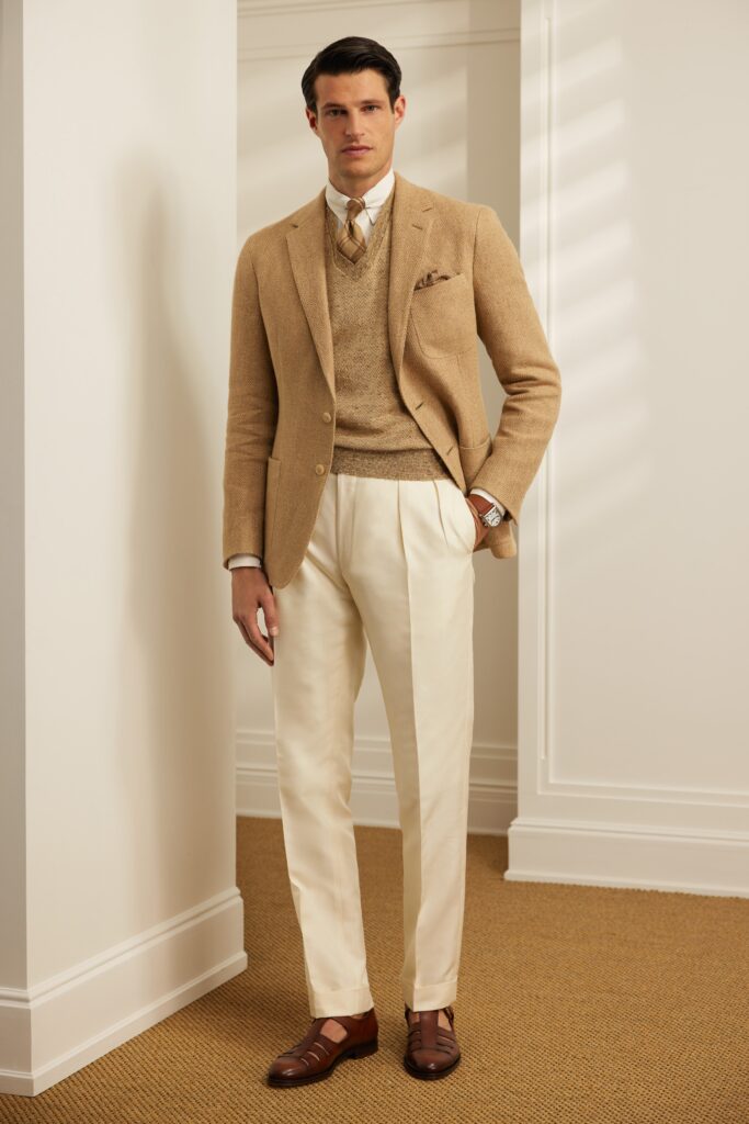 A tailored beige blazer paired with white straight-leg pants, featuring a collared design.