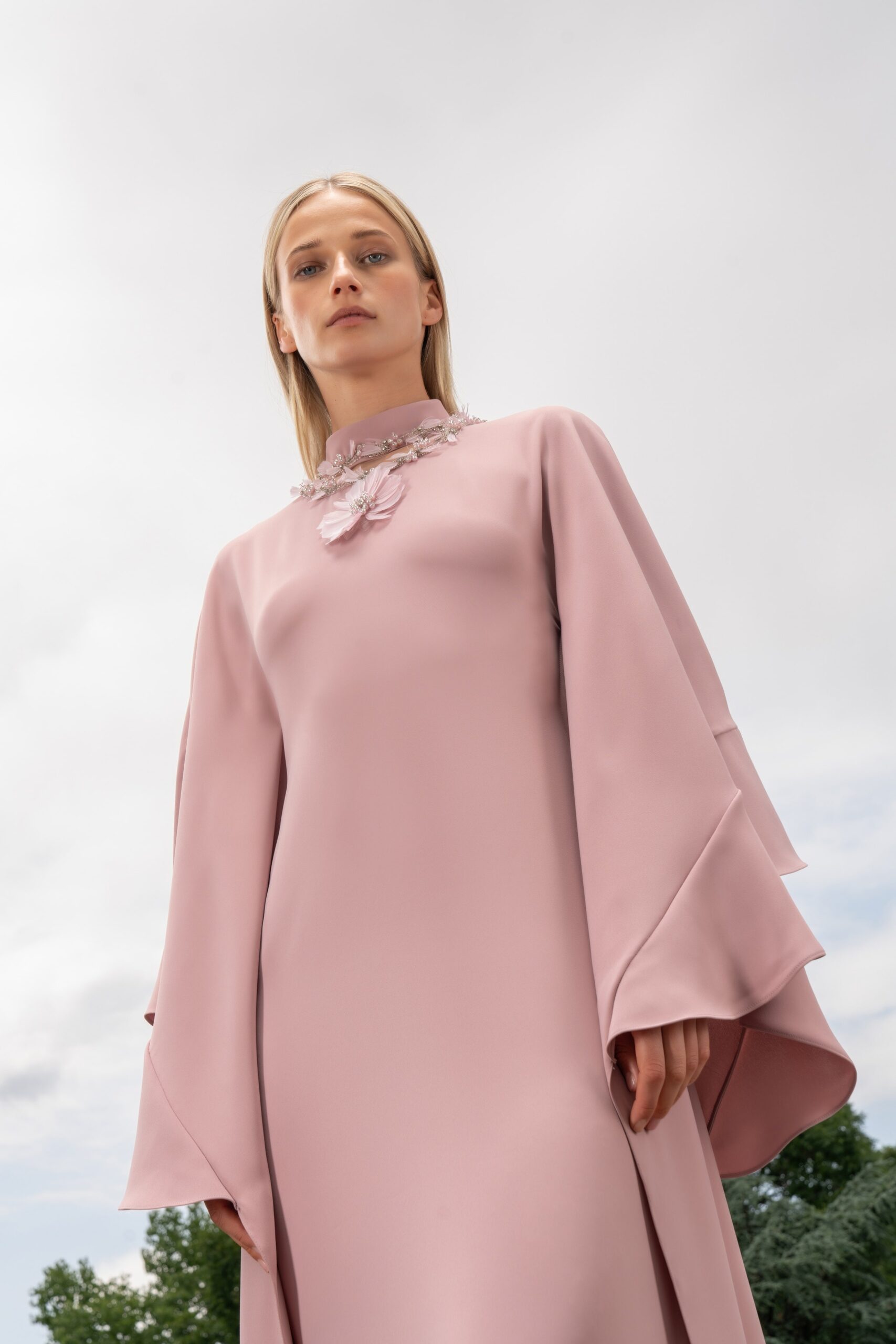 A relaxed pink silk long-sleeve dress with high-neck and embroidered details.