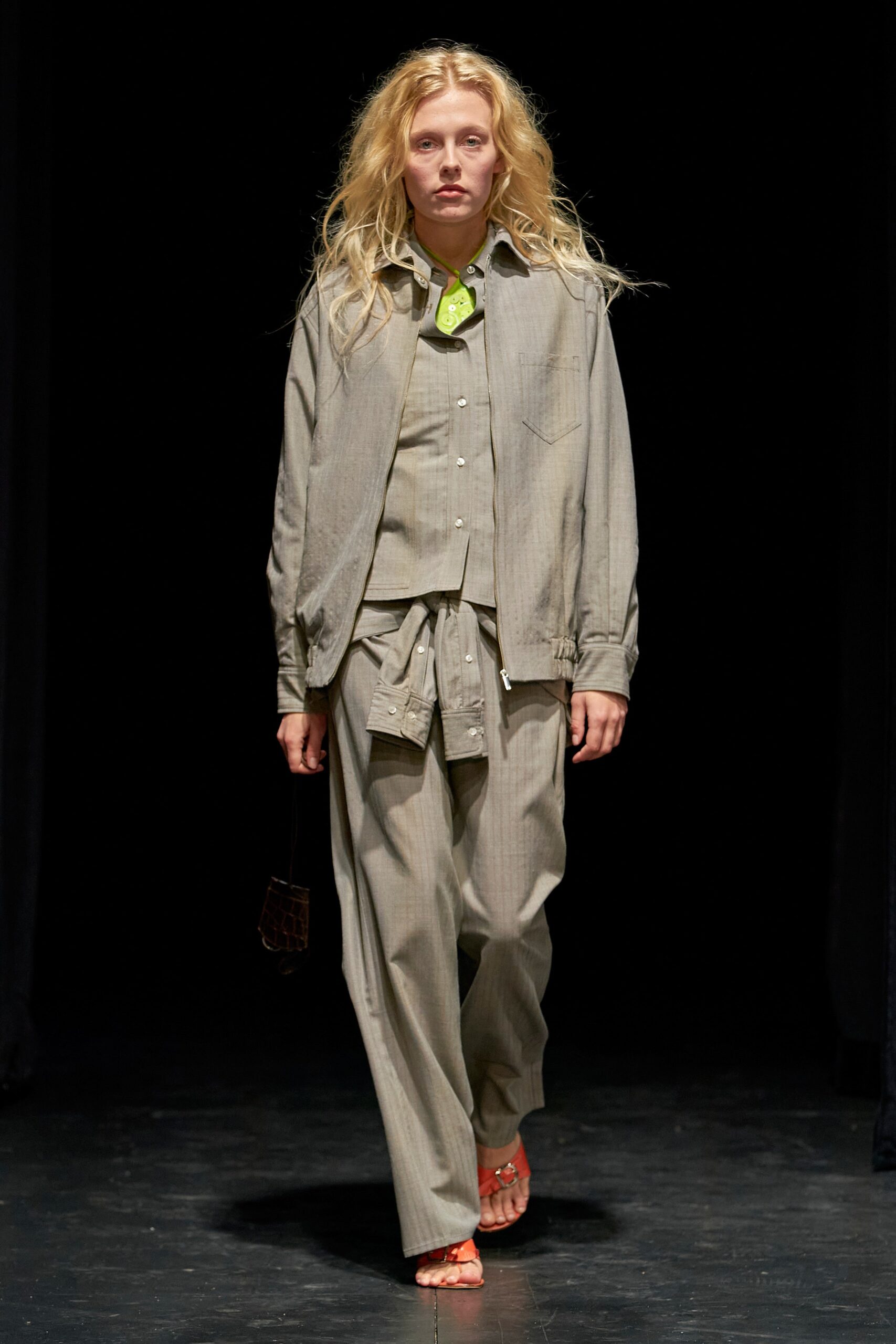 A relaxed beige cotton jacket with long sleeves and collared design, paired with matching pants.