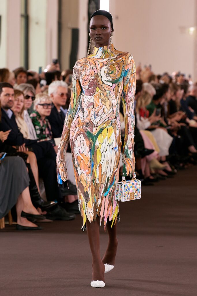 A fitted multicolor silk dress with long sleeves and an asymmetric design detail.