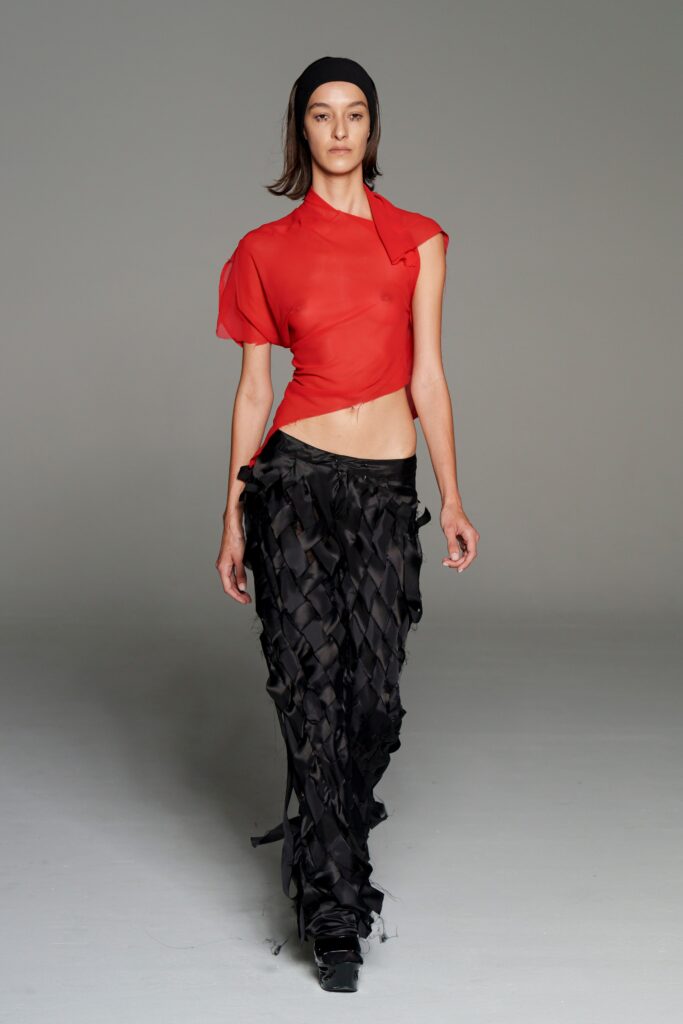 red chiffon top with black pants