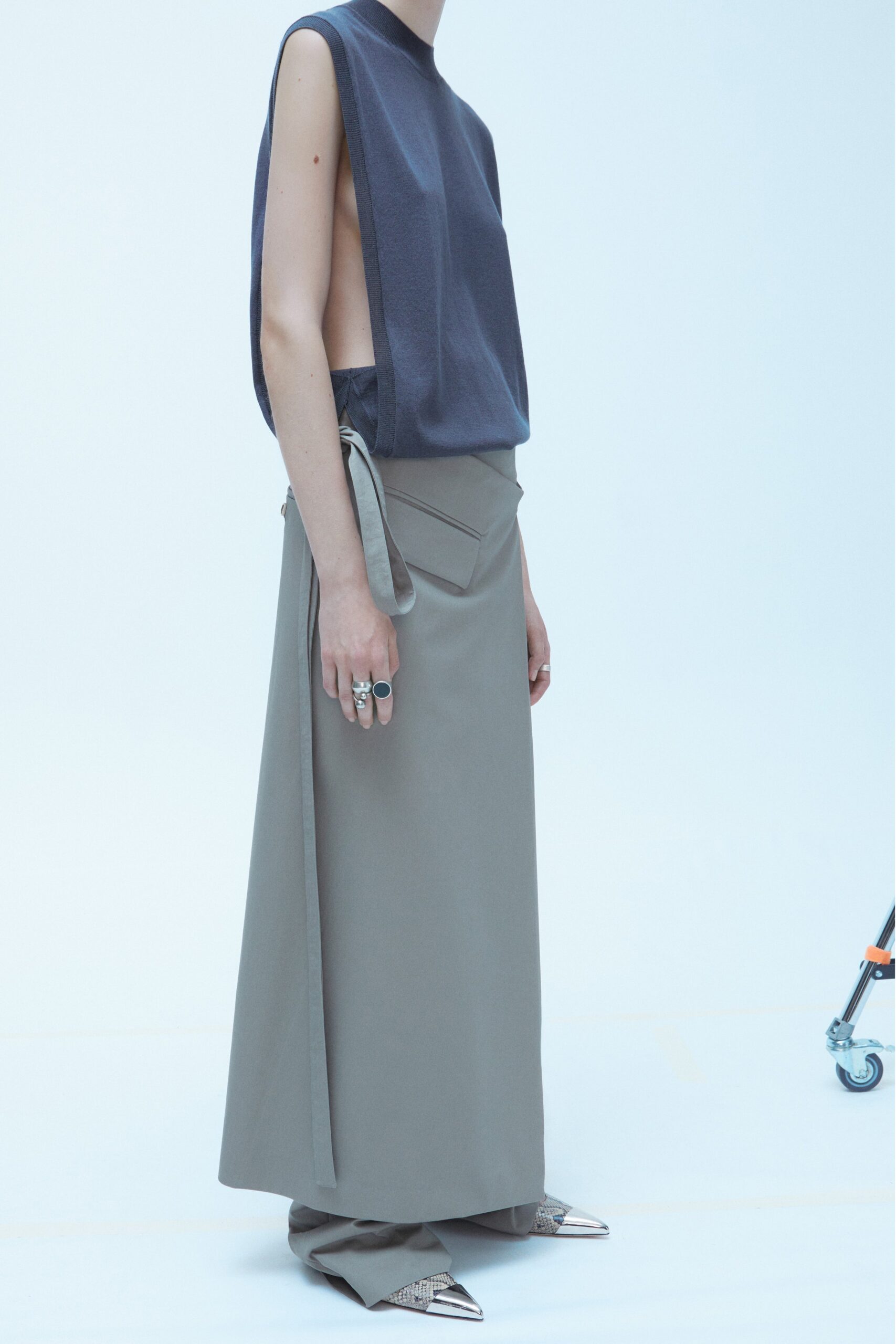 A relaxed gray sleeveless top with a high-neck and an asymmetric skirt.