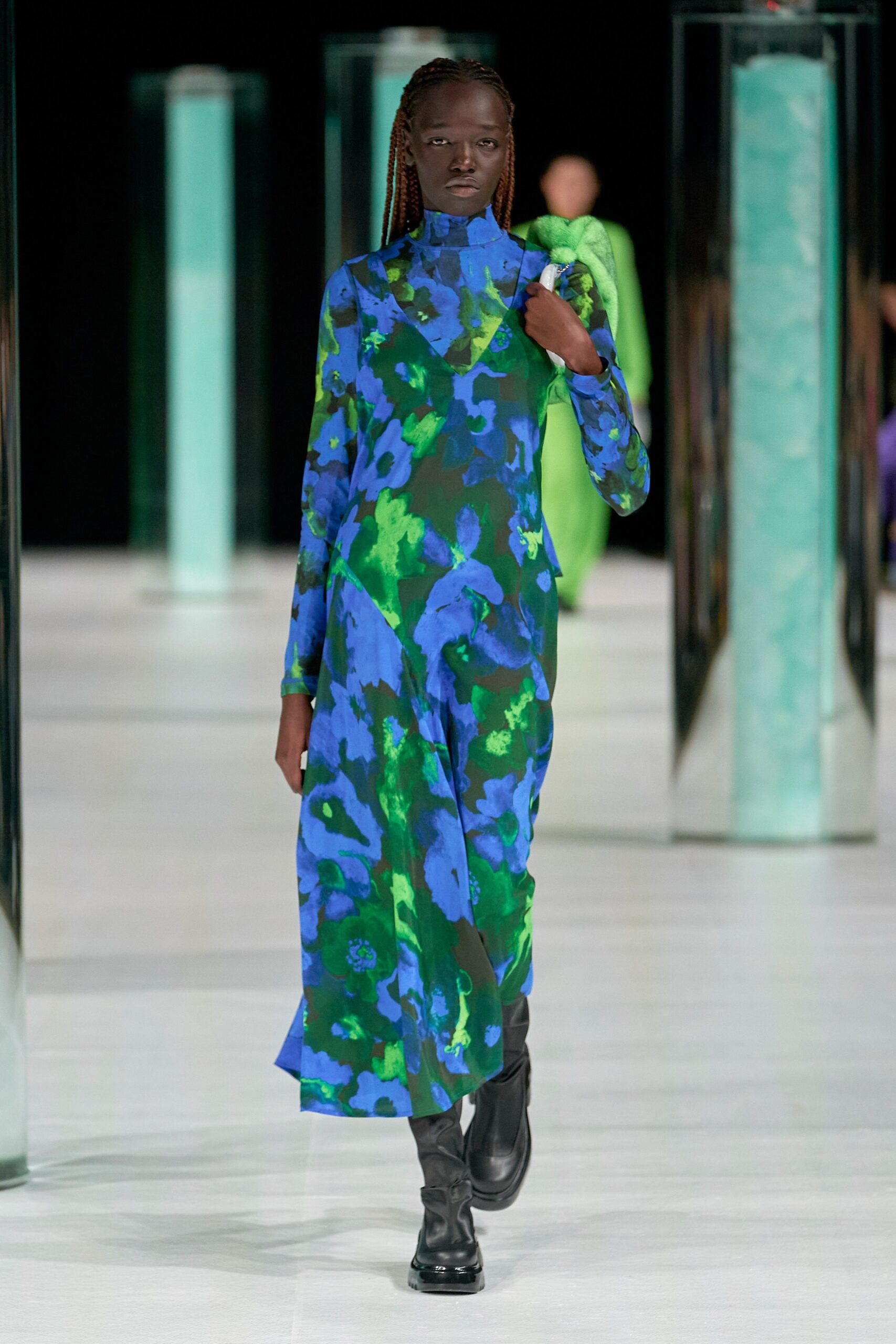 A relaxed blue and green printed dress with long sleeves and a high neckline.