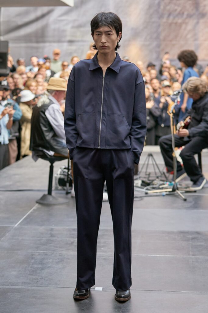 A relaxed navy cotton jacket with long sleeves and collared design paired with matching pants.