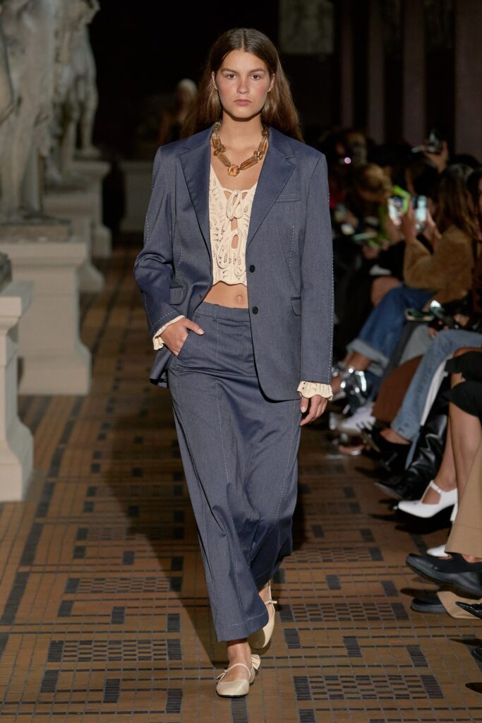 A relaxed blue cotton suit with a collared long-sleeve top and buttoned details.