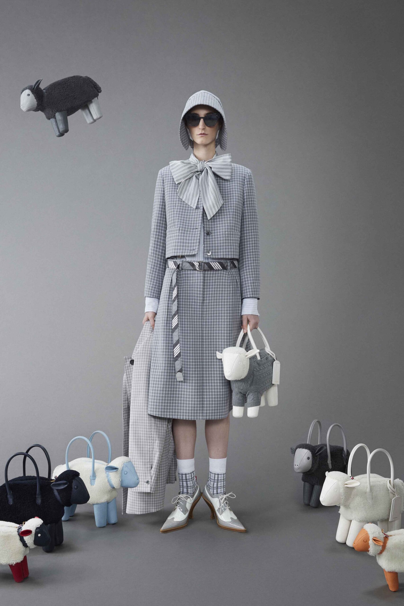 A fitted gray checked coat with a collared long-sleeve design paired with a matching skirt.
