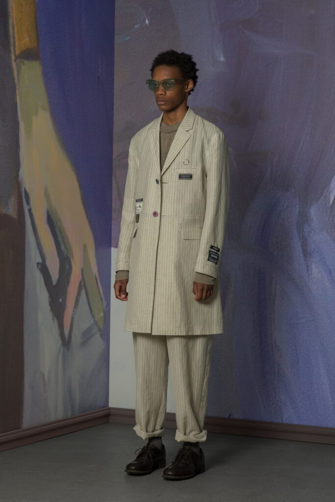 A relaxed beige striped suit with a collared long-sleeve jacket.