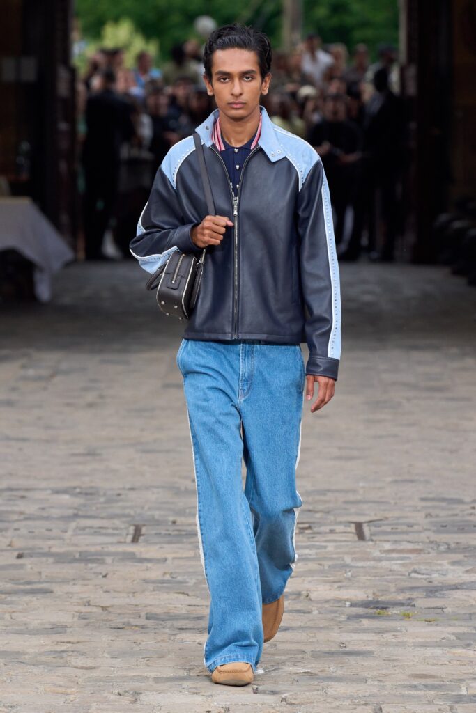A relaxed blue denim jacket paired with wide-leg black pants, featuring a collared design.