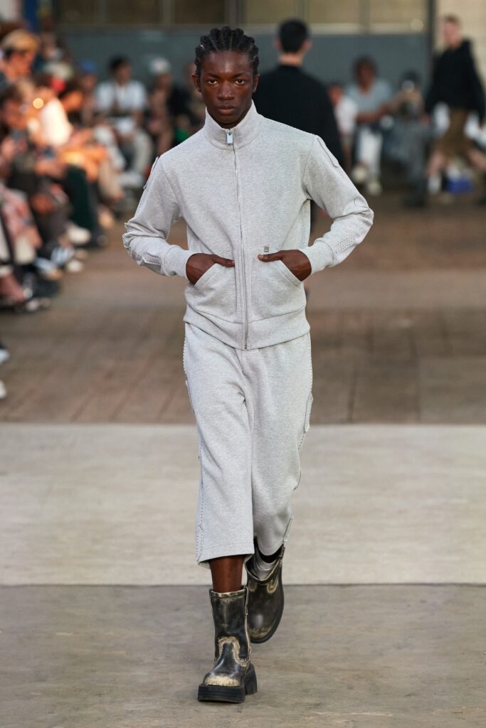 A relaxed gray cotton jacket with long sleeves and matching pants featuring a zippered detail.