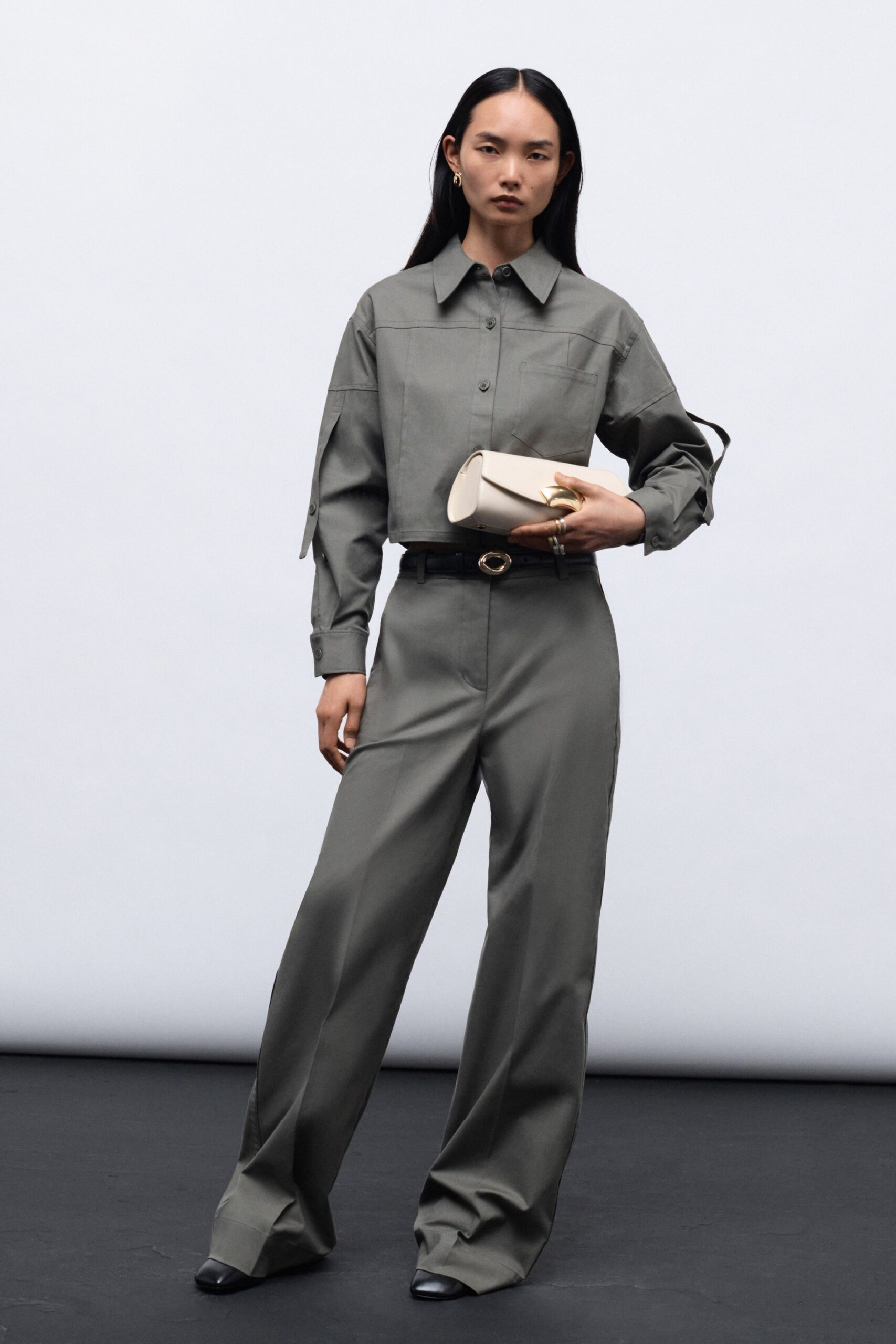 A relaxed gray cotton long-sleeve shirt with collared design paired with straight-leg pants.