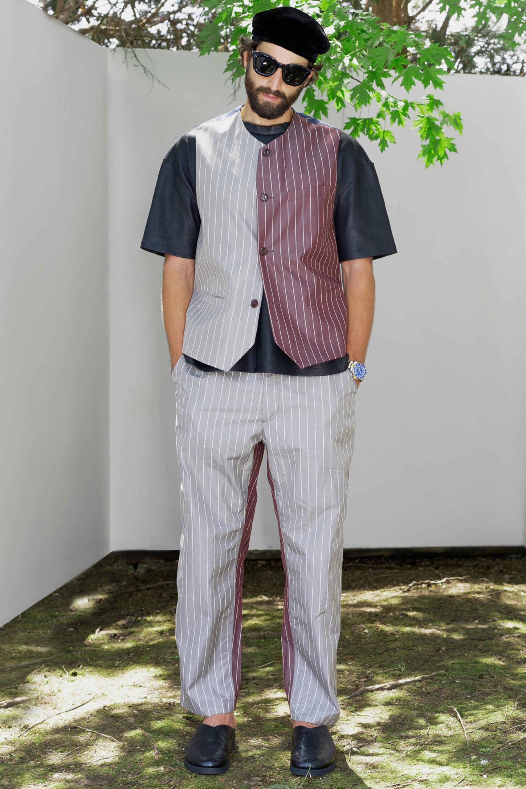 A relaxed-fit gray and brown striped vest paired with matching pants, featuring short sleeves and a collared design.