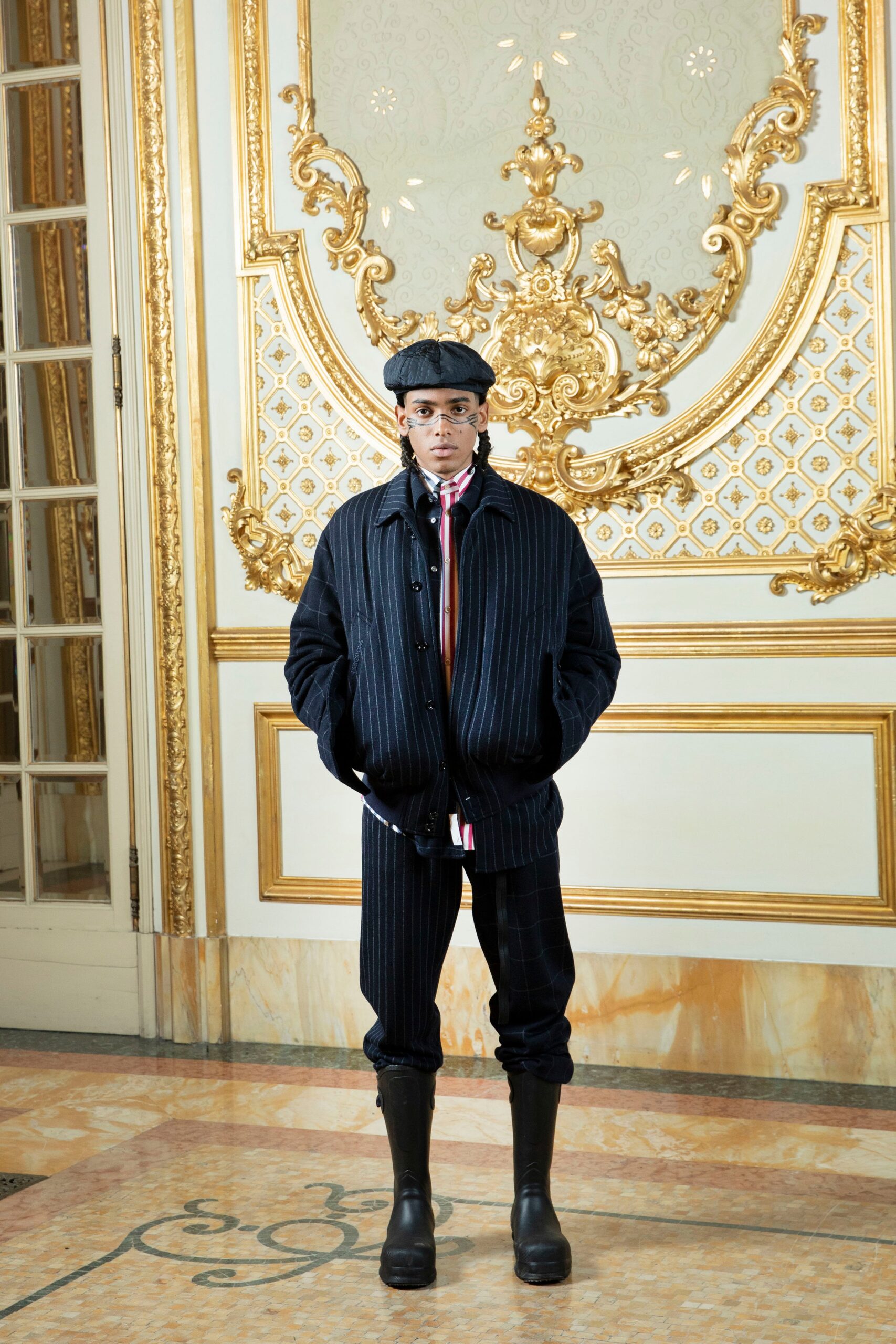 A relaxed black striped jacket with long sleeves and matching pants, featuring a collared design.