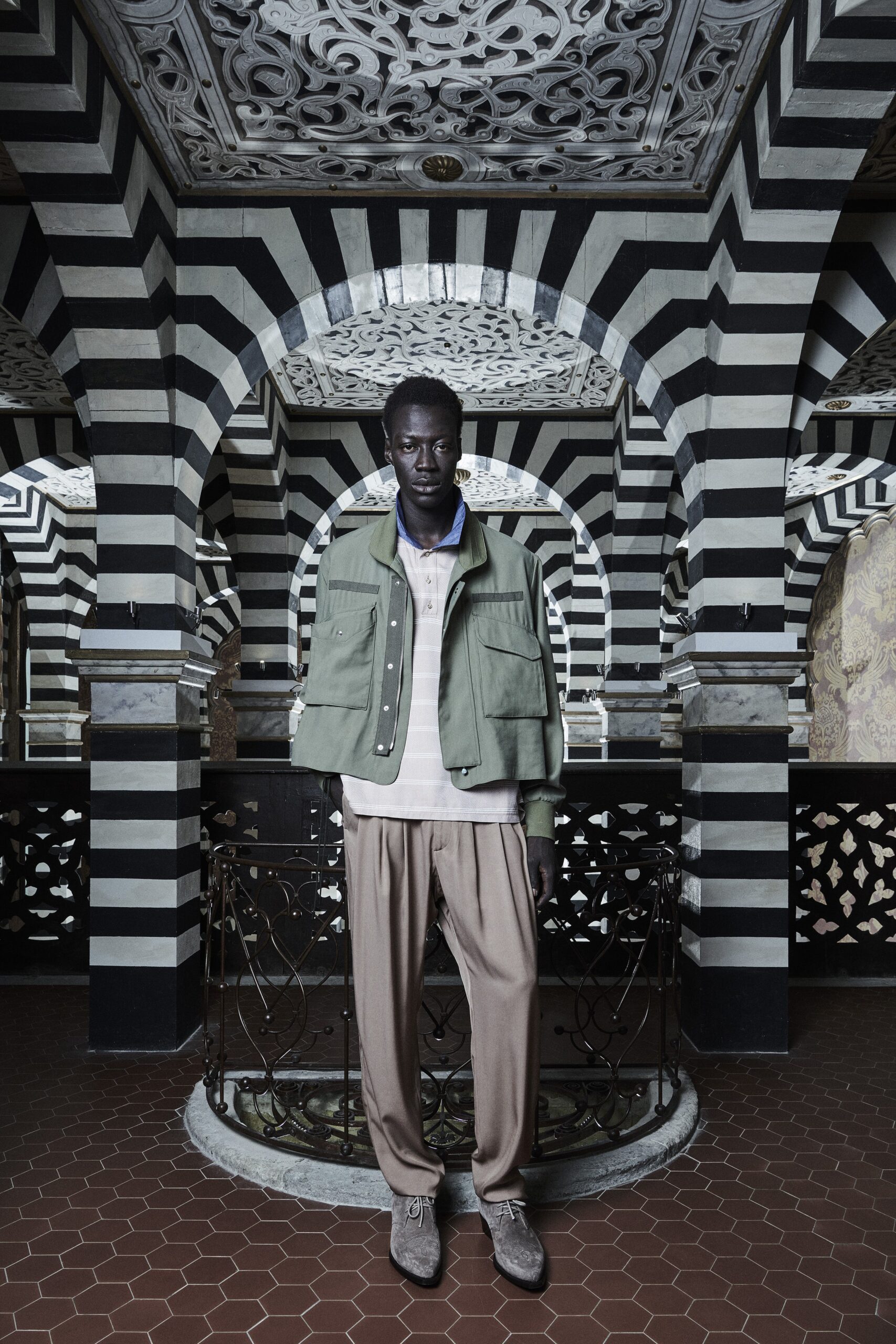 A relaxed green cotton jacket paired with beige wide-leg pants and a collared shirt.