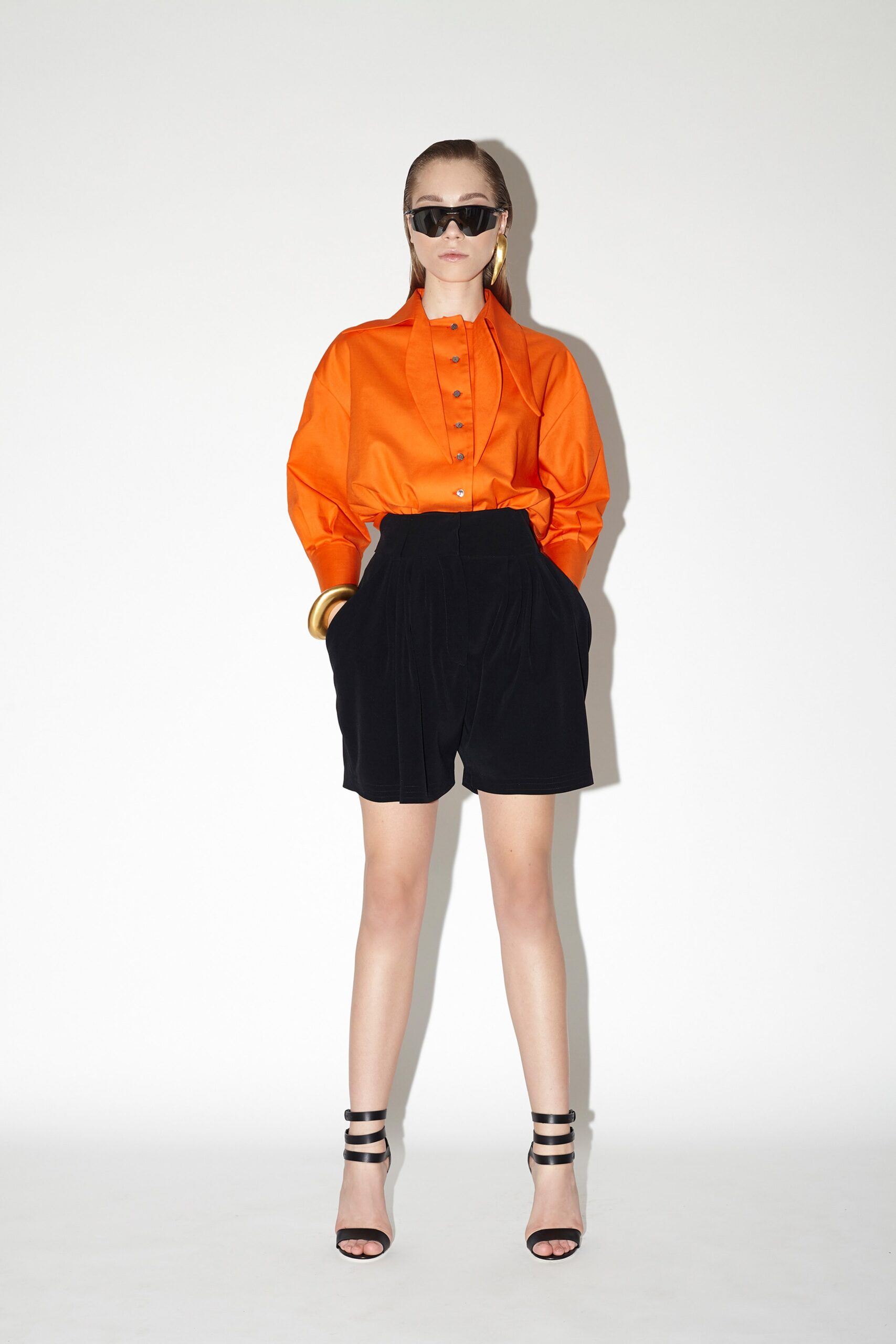 orange relaxed shirt with black shorts
