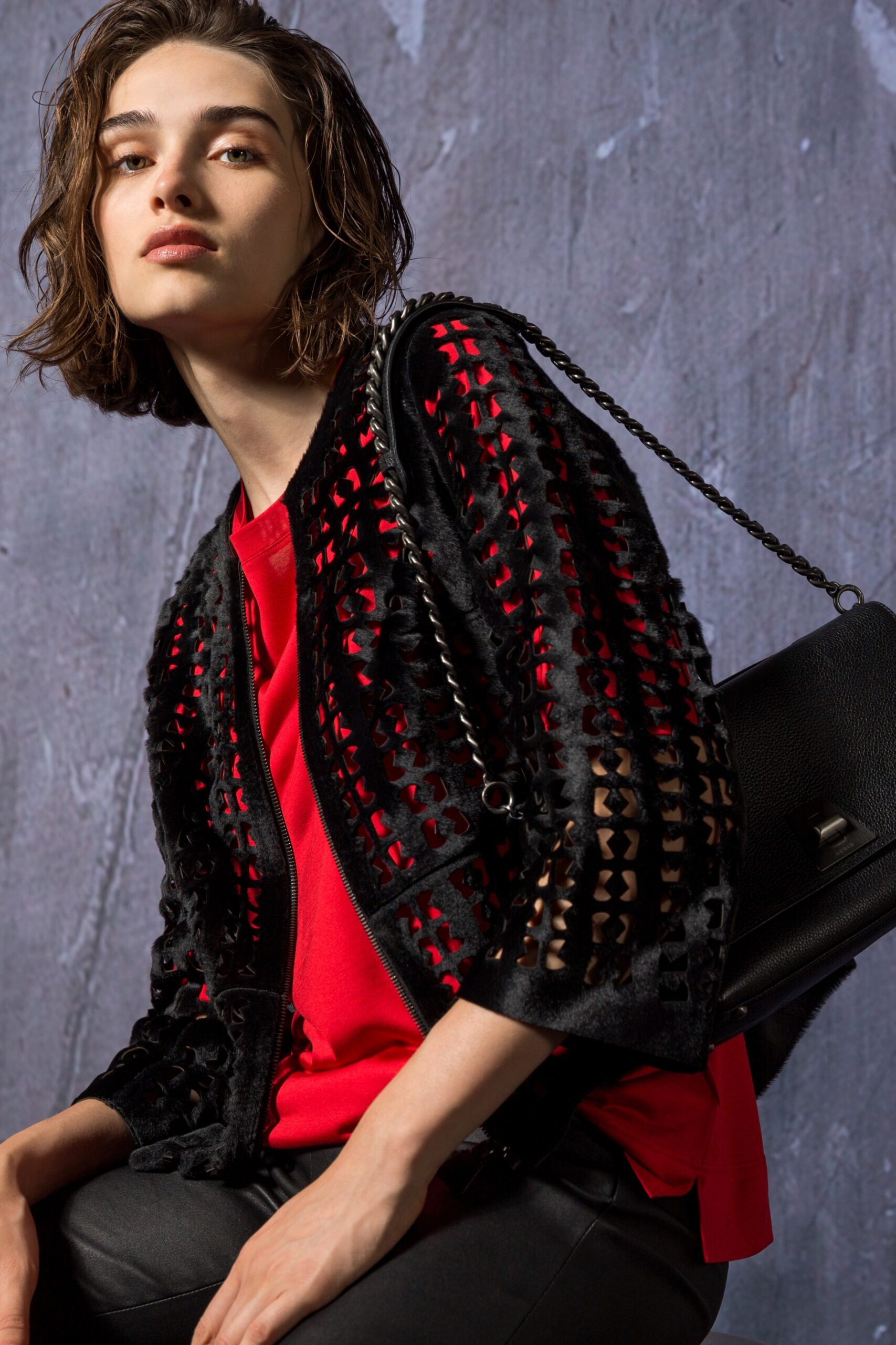 black leather jacket and red top