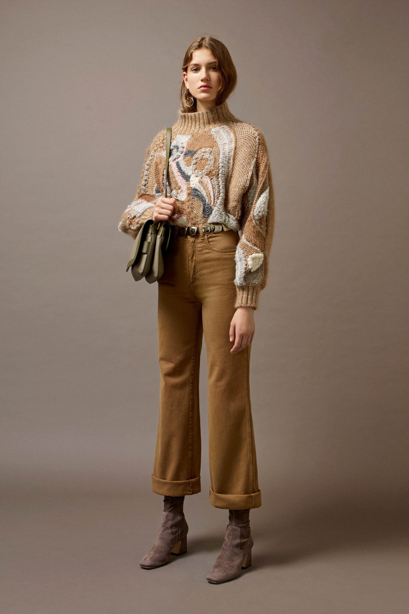 beige embroidered sweater with brown pants