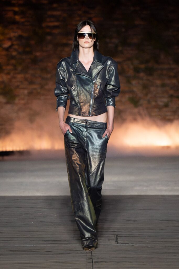 A fitted silver leather jacket with a collared neckline paired with straight-leg pants.