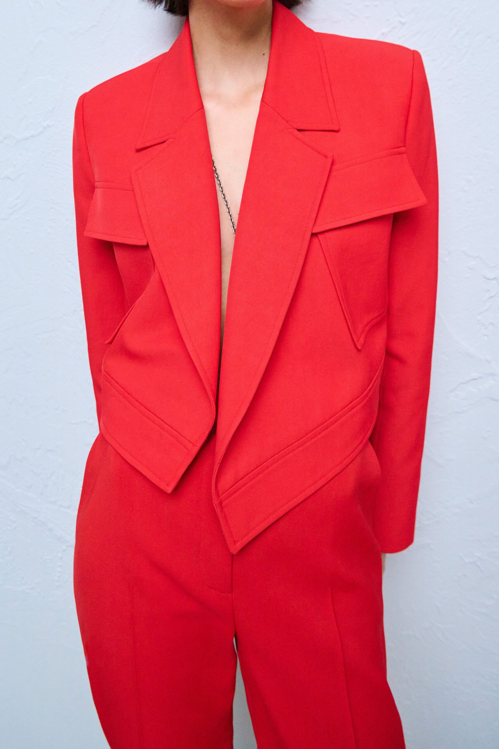 red structured blazer and tailored pants