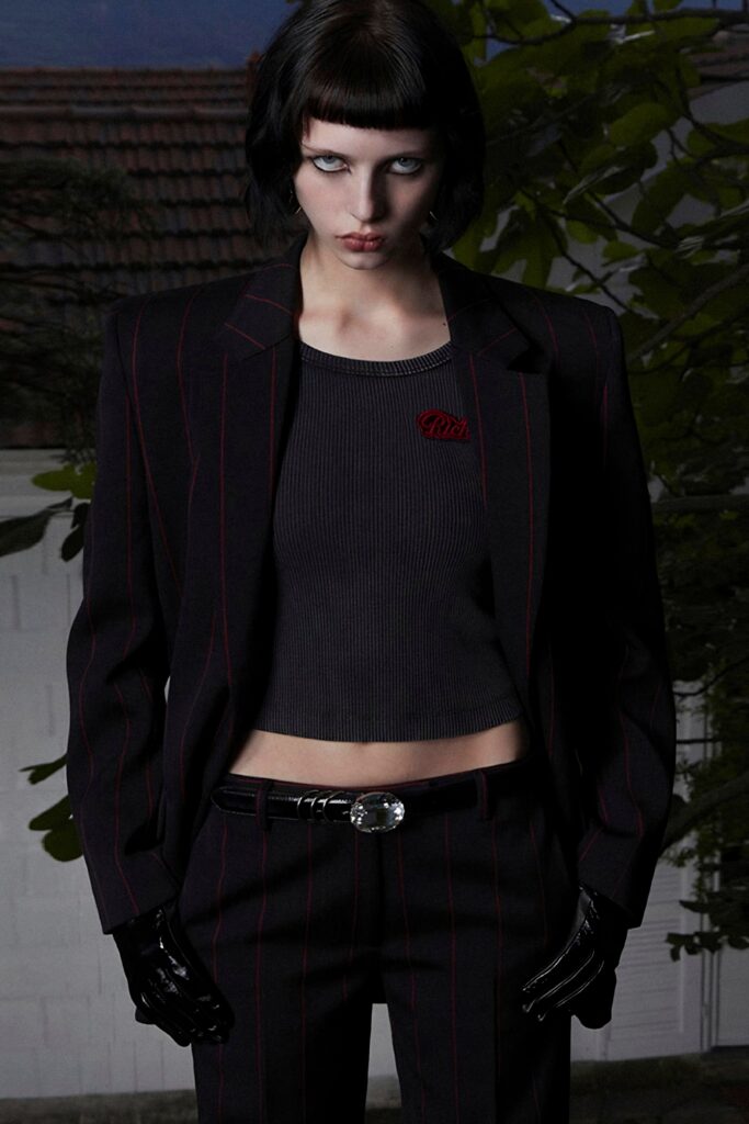 A fitted black striped blazer paired with matching pants, featuring a collared design.