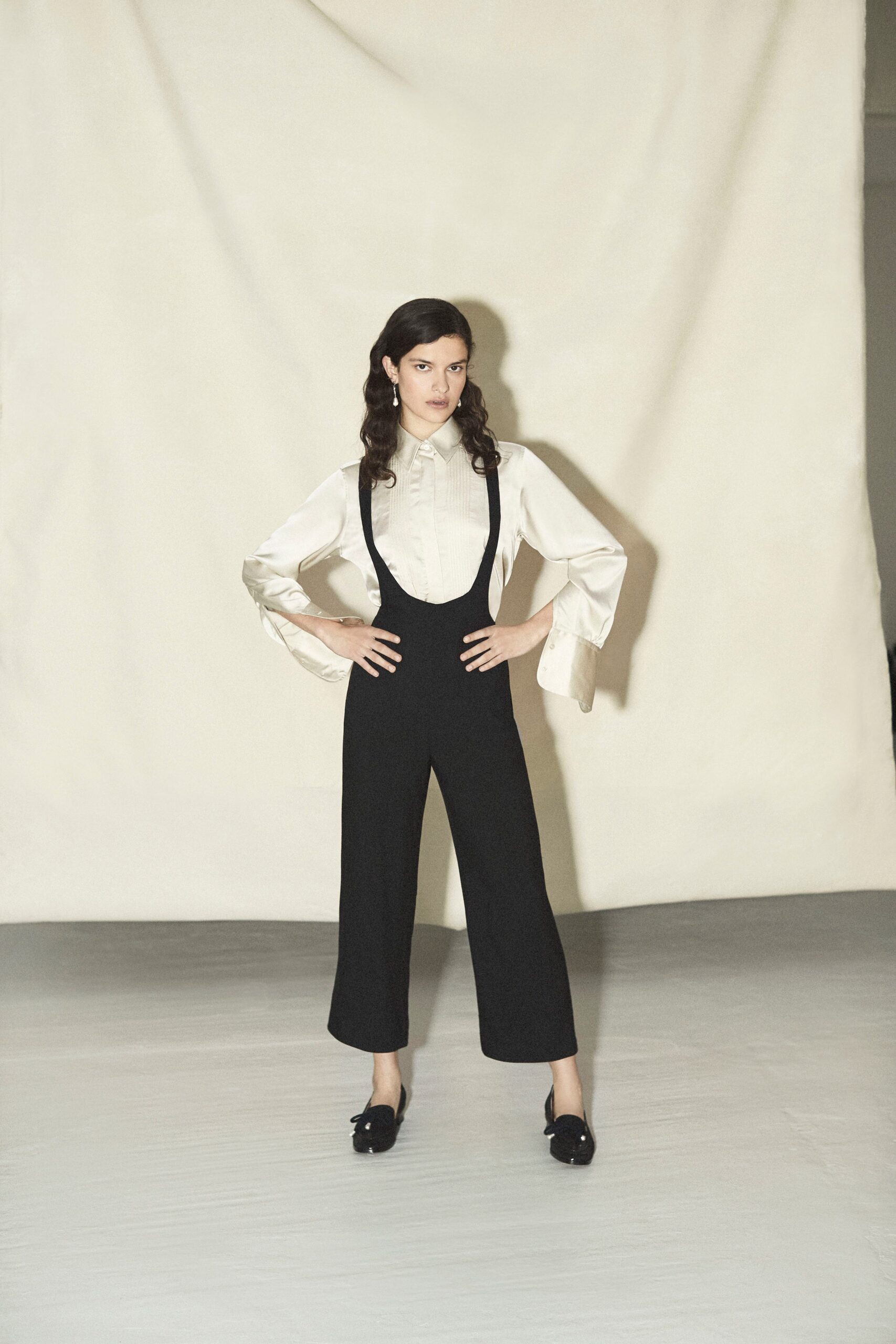white silk blouse and black jumpsuit