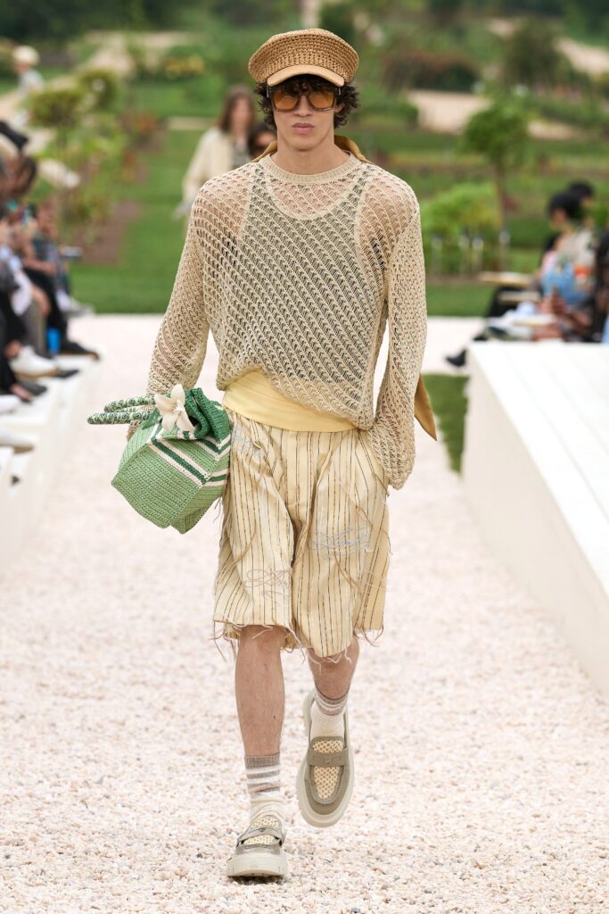 A relaxed beige cotton top with short sleeves paired with striped shorts.
