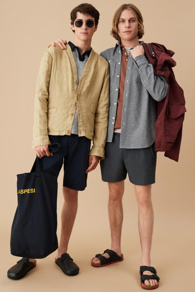 A relaxed beige long-sleeve collared shirt paired with gray shorts.