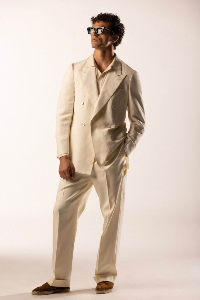 A tailored beige linen suit with long sleeves and a double-breasted design.